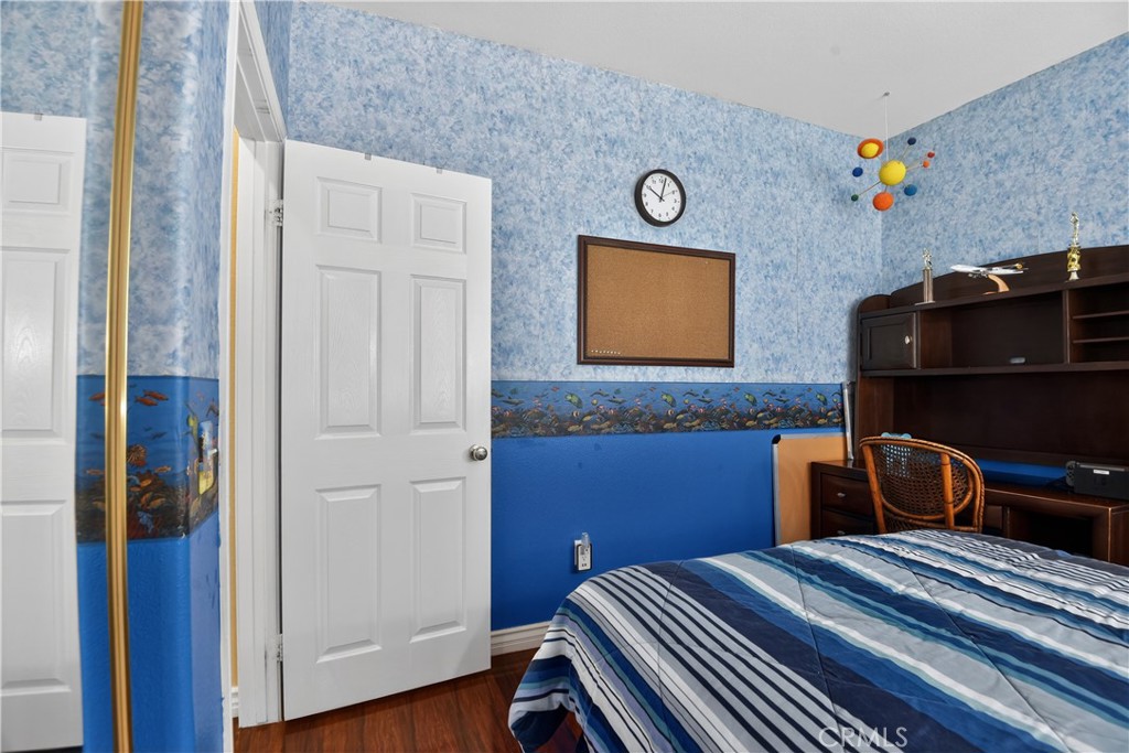 2621 Fallen Leaf Court Simi Valley, CA 93063 - Photo 47 of 58 a bedroom with a bed and wooden floor