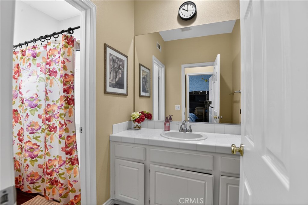 2621 Fallen Leaf Court Simi Valley, CA 93063 - Photo 49 of 58 a bathroom with a sink vanity and a mirror