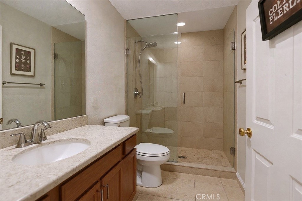 2621 Fallen Leaf Court Simi Valley, CA 93063 - Photo 52 of 58 a bathroom with a granite countertop sink a toilet and shower