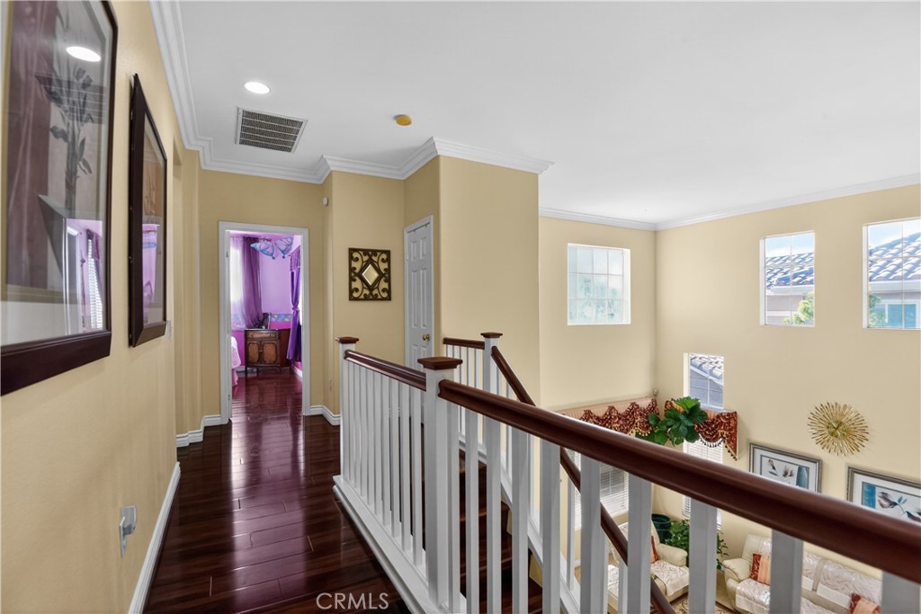 2621 Fallen Leaf Court Simi Valley, CA 93063 - Photo 54 of 58 a view of a hallway with wooden floor and stairs