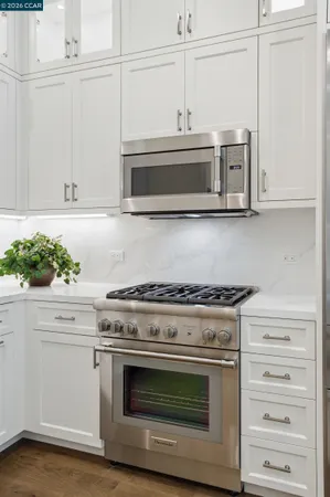 a stove top oven sitting inside of a kitchen