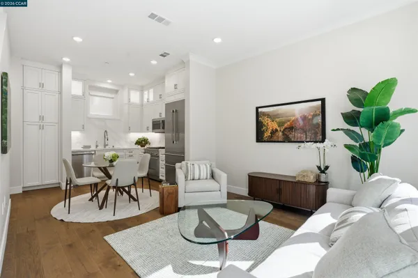 a living room with furniture a dining table and a potted plant