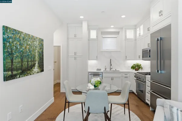 a kitchen with stainless steel appliances kitchen island granite countertop a refrigerator and a stove top oven