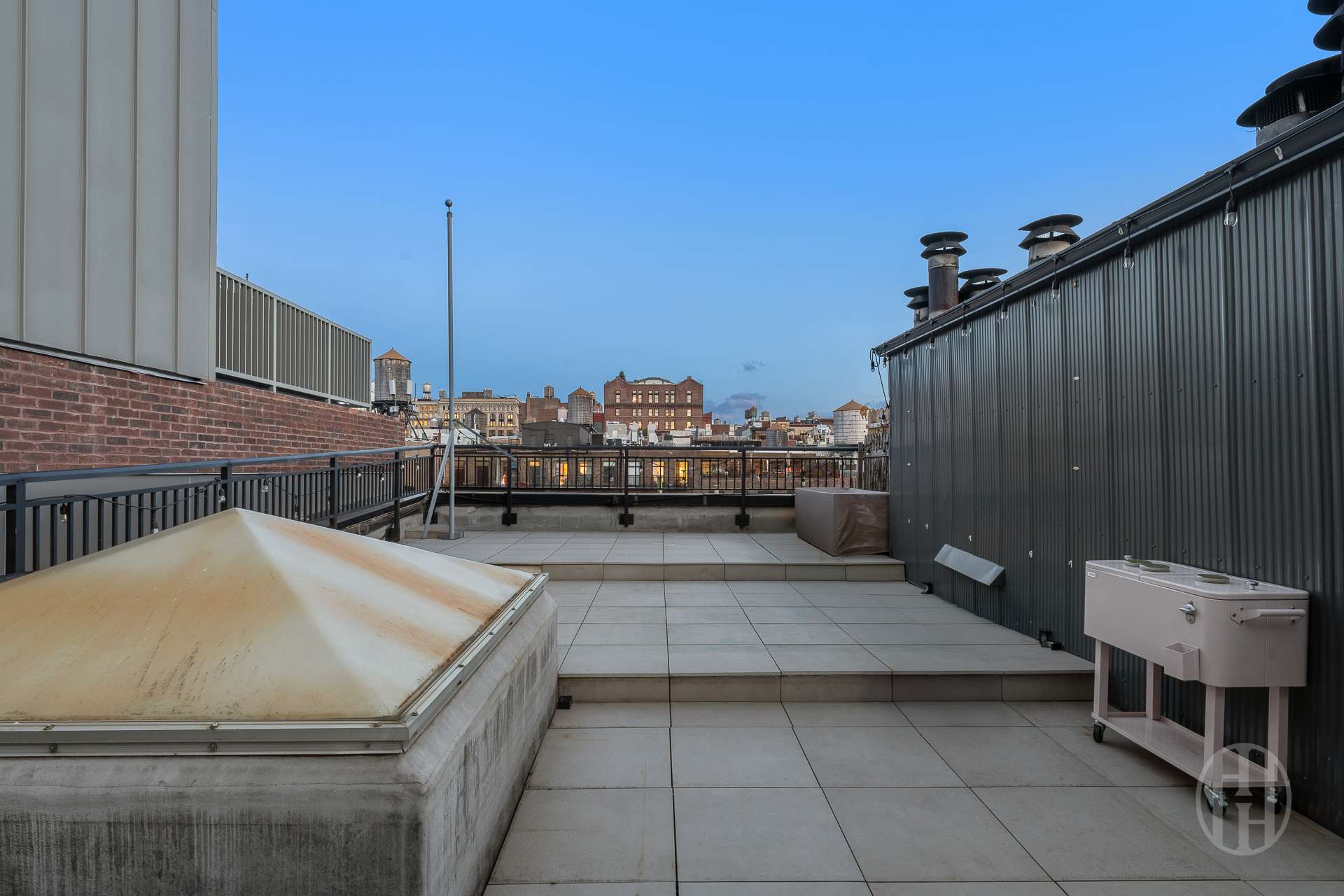 426 West Broadway, Unit 6F Manhattan, NY 10012 - Photo 11 of 13 a terrace with outdoor seating and city view