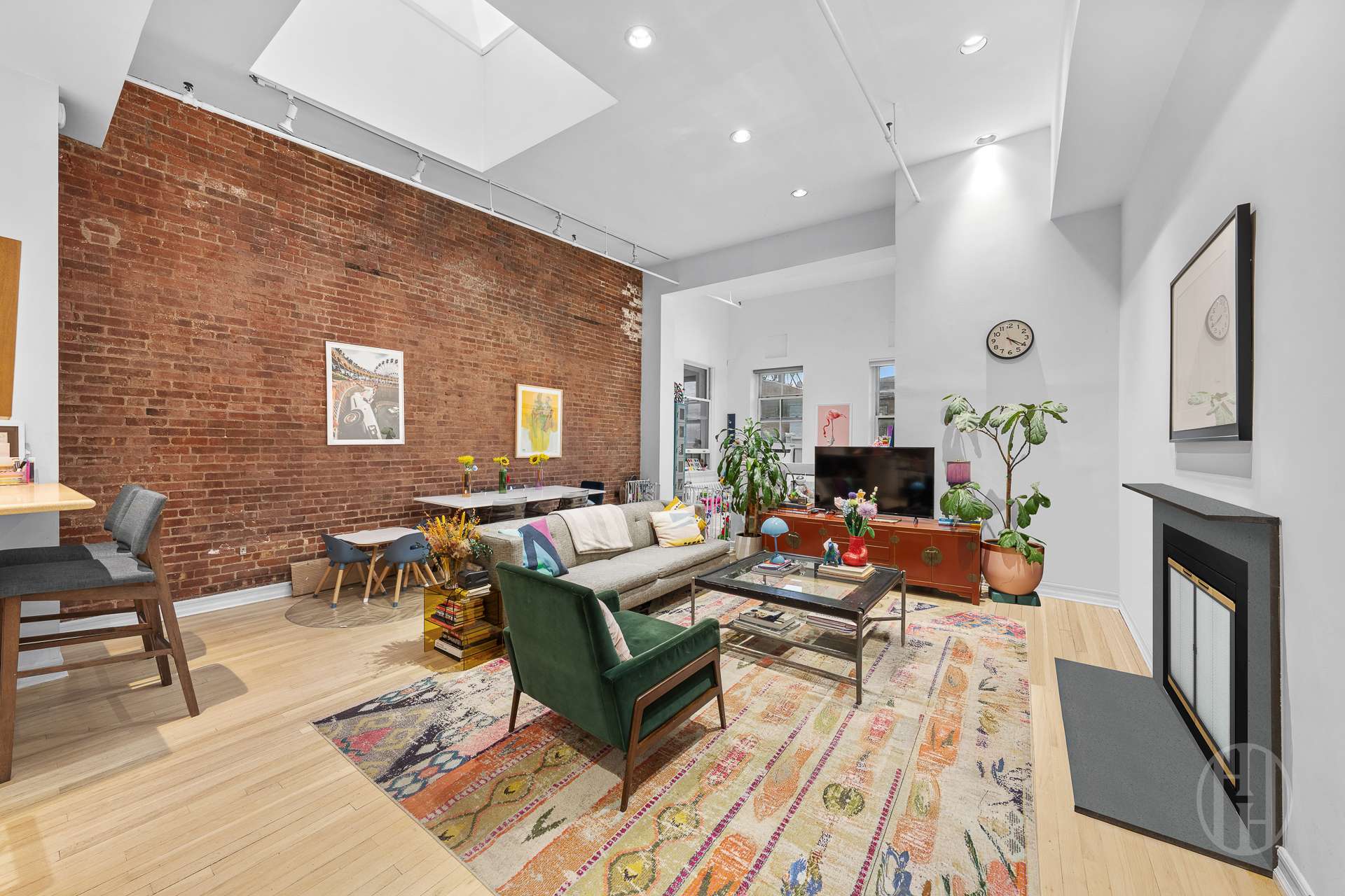 426 West Broadway, Unit 6F Manhattan, NY 10012 - Photo 2 of 13 a living room with fireplace furniture and a rug