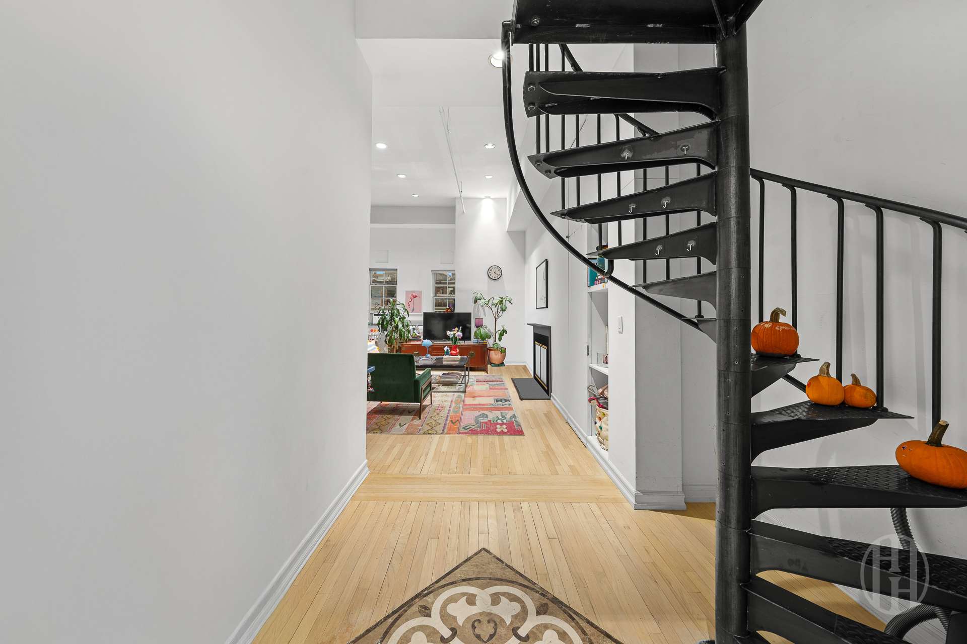 426 West Broadway, Unit 6F Manhattan, NY 10012 - Photo 4 of 13 a view of staircase with lots of frames on wall and a potted plant