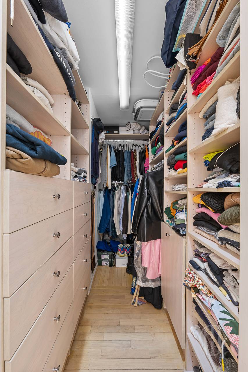 426 West Broadway, Unit 6F Manhattan, NY 10012 - Photo 6 of 13 a view of walk in closet with clothes