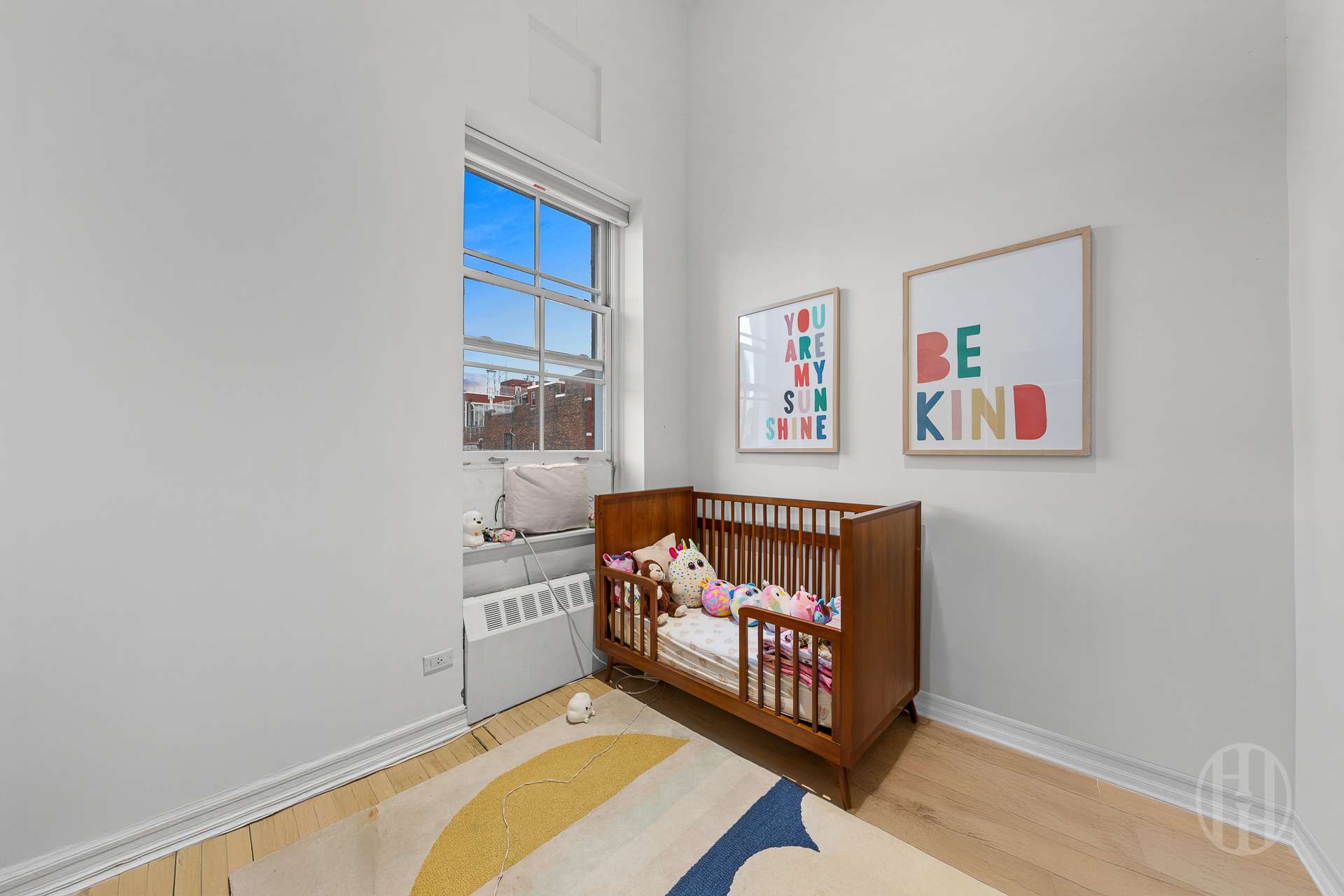 426 West Broadway, Unit 6F Manhattan, NY 10012 - Photo 7 of 13 a room with furniture and a window
