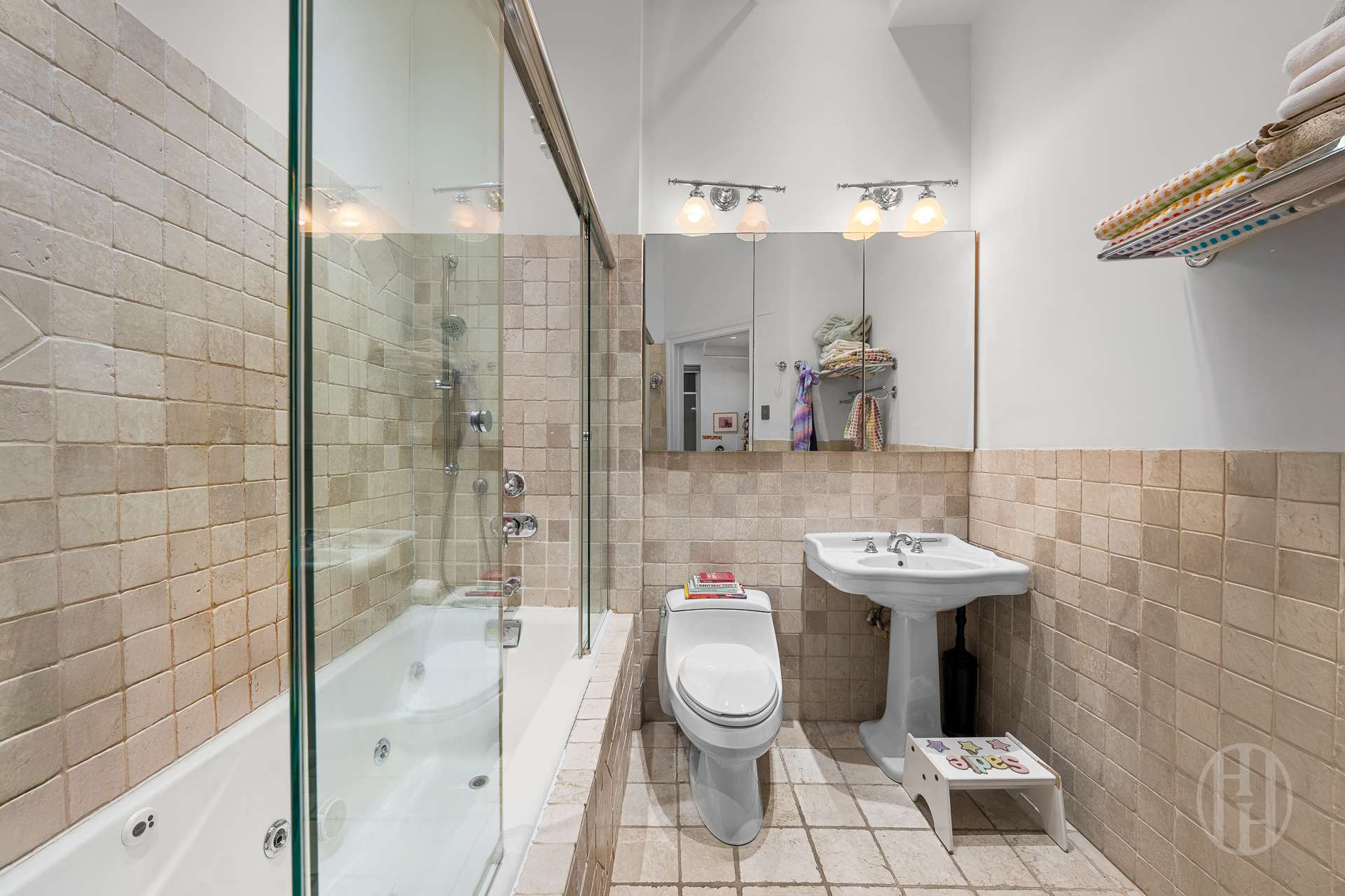 426 West Broadway, Unit 6F Manhattan, NY 10012 - Photo 9 of 13 a bathroom with a sink a toilet and shower