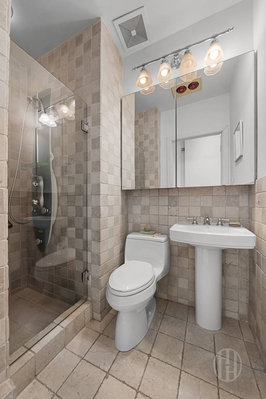 426 West Broadway, Unit 6F Manhattan, NY 10012 - Photo 10 of 13 a bathroom with a sink toilet and shower