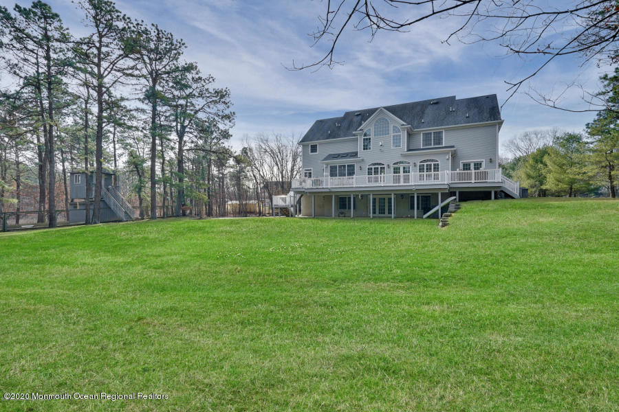 129 Arnold Boulevard Howell, NJ 07731 - Photo 3 of 3 a view of a house with a big yard and large trees