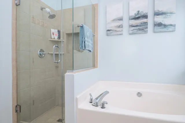 a bathroom with a granite countertop shower a sink a toilet and a mirror