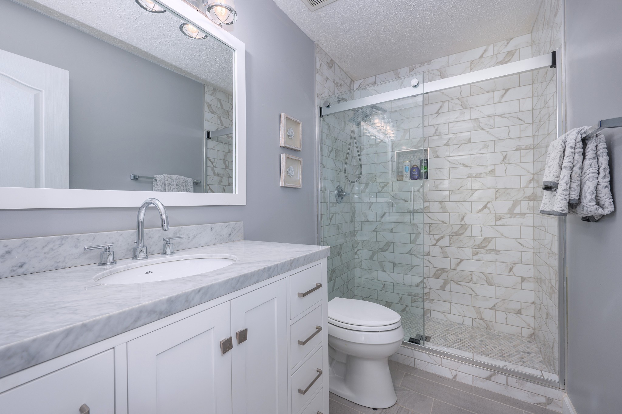 2763 Rosedale Place Nashville, TN 37211 - Photo 22 of 40 a bathroom with a granite countertop shower a sink a toilet and a mirror