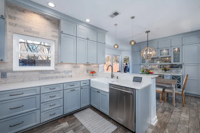 a kitchen with a sink cabinets and window