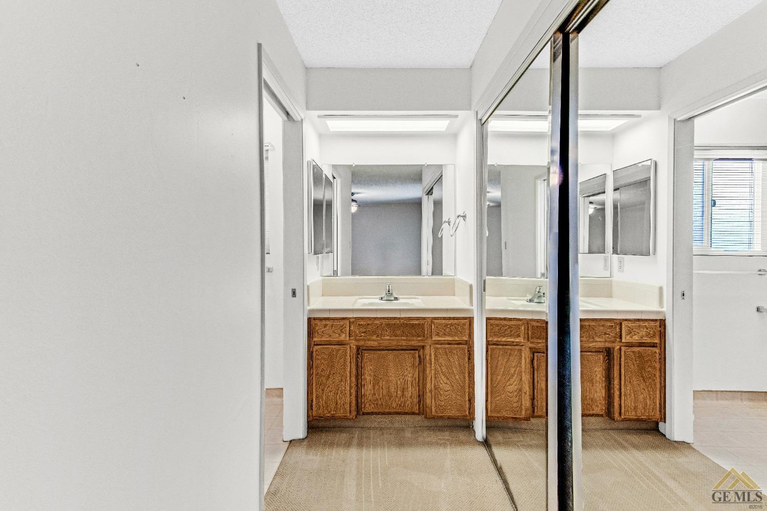 Undisclosed Address Bakersfield, CA 93311 - Photo 18 of 50 a view of a bathroom with a sink and mirror