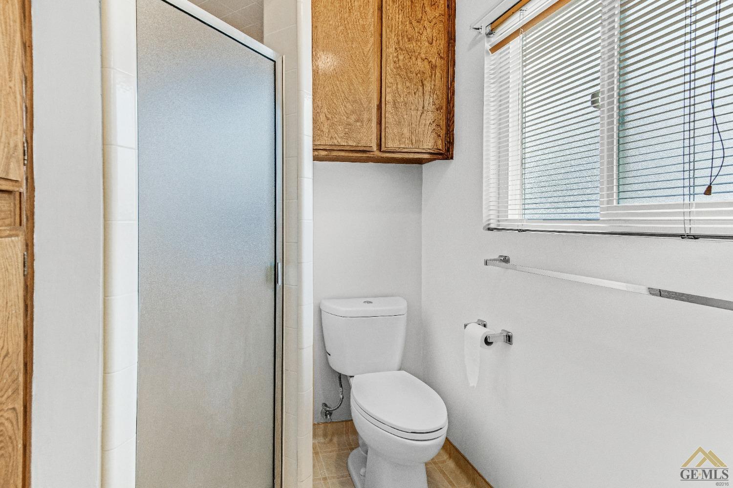 Undisclosed Address Bakersfield, CA 93311 - Photo 19 of 50 a white toilet sitting next to a bathroom sink