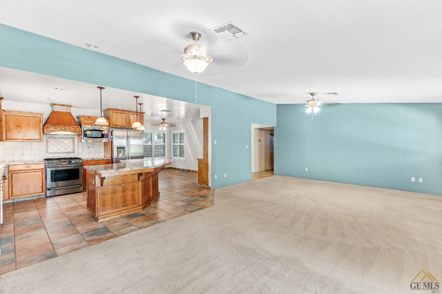 Undisclosed Address Bakersfield, CA 93311 - Photo 22 of 50 a view of a kitchen with kitchen island stainless steel appliances a stove and cabinets