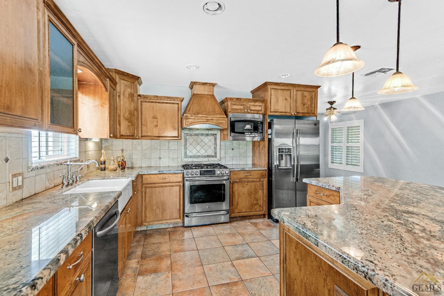 Undisclosed Address Bakersfield, CA 93311 - Photo 24 of 50 a kitchen with a stove and a sink