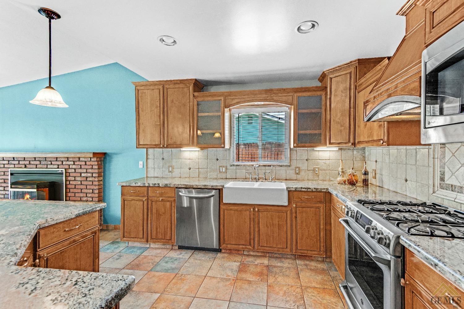 Undisclosed Address Bakersfield, CA 93311 - Photo 26 of 50 a kitchen with stainless steel appliances granite countertop a stove a sink and a microwave