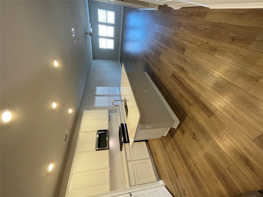 105 Sungrove Trail Georgetown, TX 78628 - Photo 2 of 18 a large kitchen with stainless steel appliances a large counter top a stove and a wooden floors