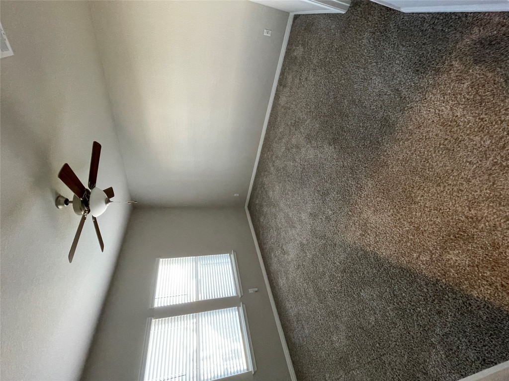 105 Sungrove Trail Georgetown, TX 78628 - Photo 5 of 18 an empty room with a ceiling fan and window