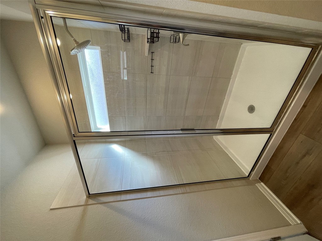 105 Sungrove Trail Georgetown, TX 78628 - Photo 7 of 18 a bathroom with a glass shower door