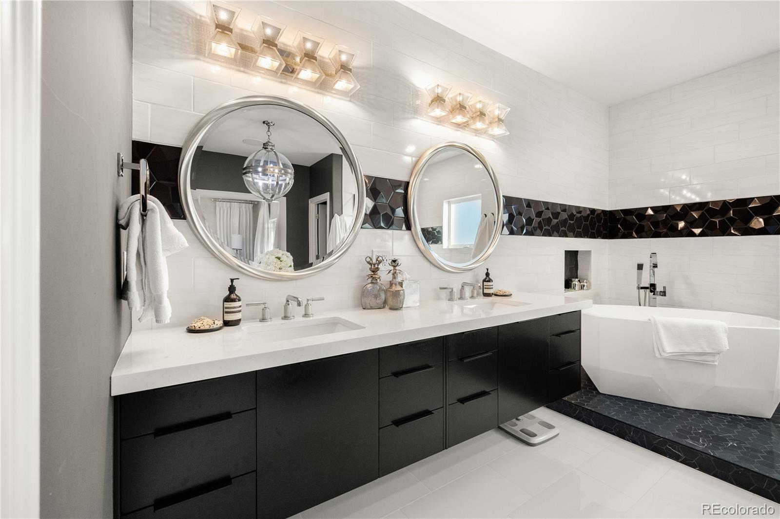 10785 Sundial Rim Road Highlands Ranch, CO 80126 - Photo 17 of 43 a bathroom with a double vanity sink and a mirror
