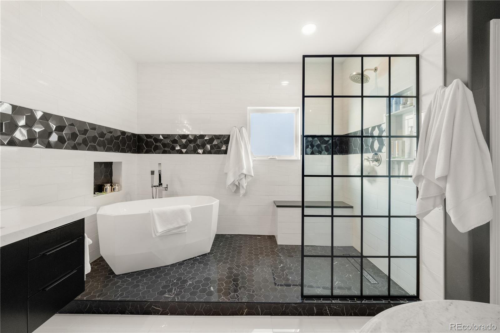 10785 Sundial Rim Road Highlands Ranch, CO 80126 - Photo 18 of 43 a spacious bathroom with a bathtub and window