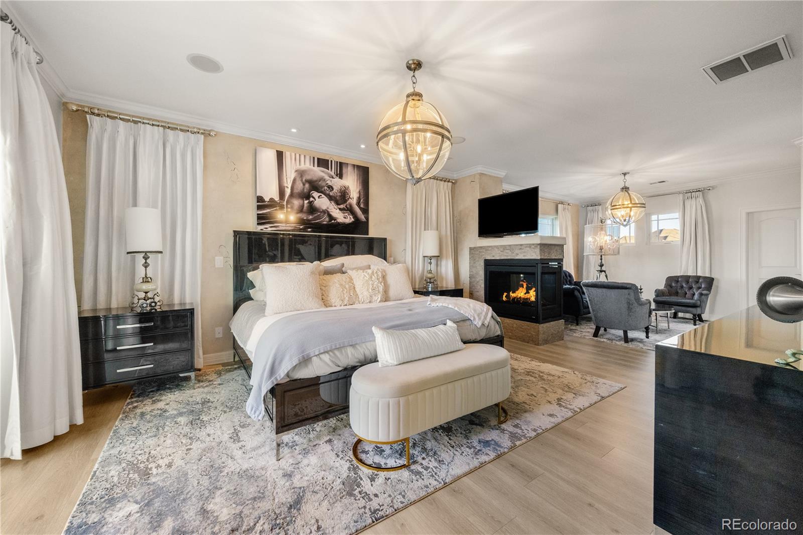 10785 Sundial Rim Road Highlands Ranch, CO 80126 - Photo 19 of 43 a living room with furniture a fireplace and a flat screen tv