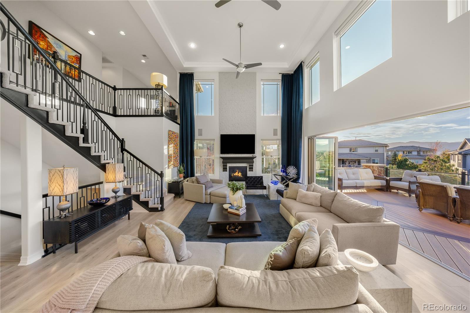 10785 Sundial Rim Road Highlands Ranch, CO 80126 - Photo 25 of 43 a living room with furniture fireplace and a flat screen tv