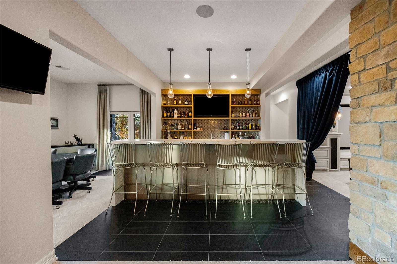 10785 Sundial Rim Road Highlands Ranch, CO 80126 - Photo 31 of 43 a kitchen with stainless steel appliances kitchen island granite countertop a stove a sink and a microwave