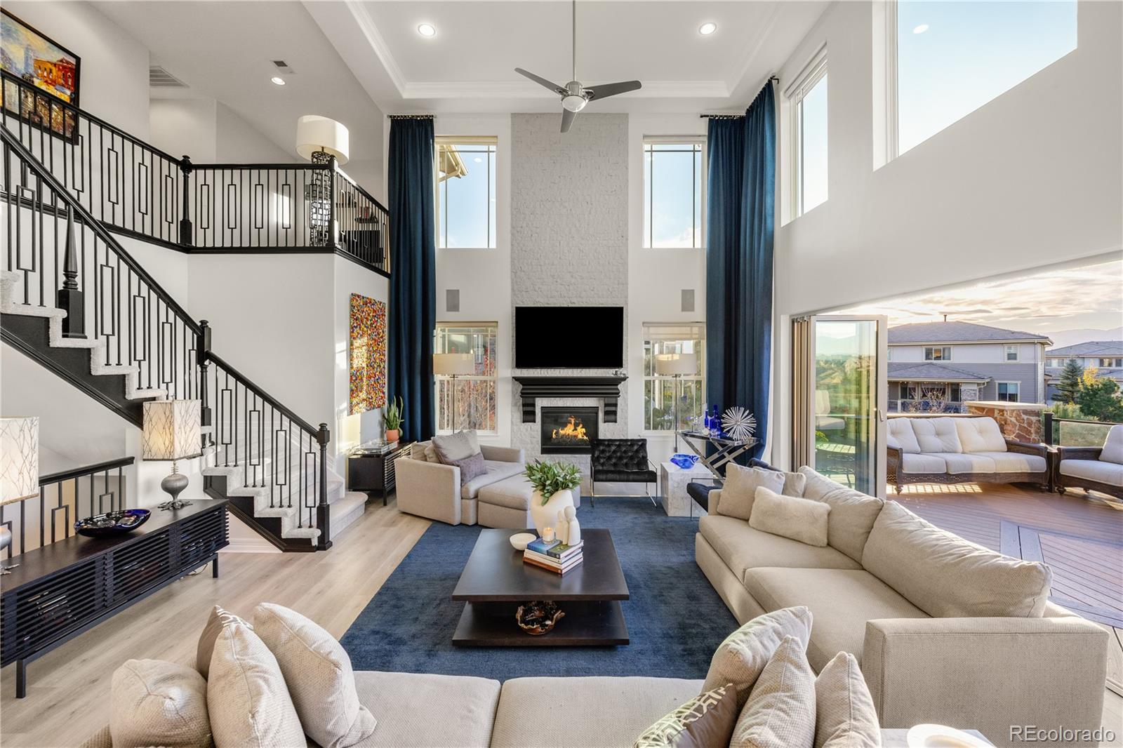 10785 Sundial Rim Road Highlands Ranch, CO 80126 - Photo 5 of 43 a living room with furniture fireplace and a flat screen tv