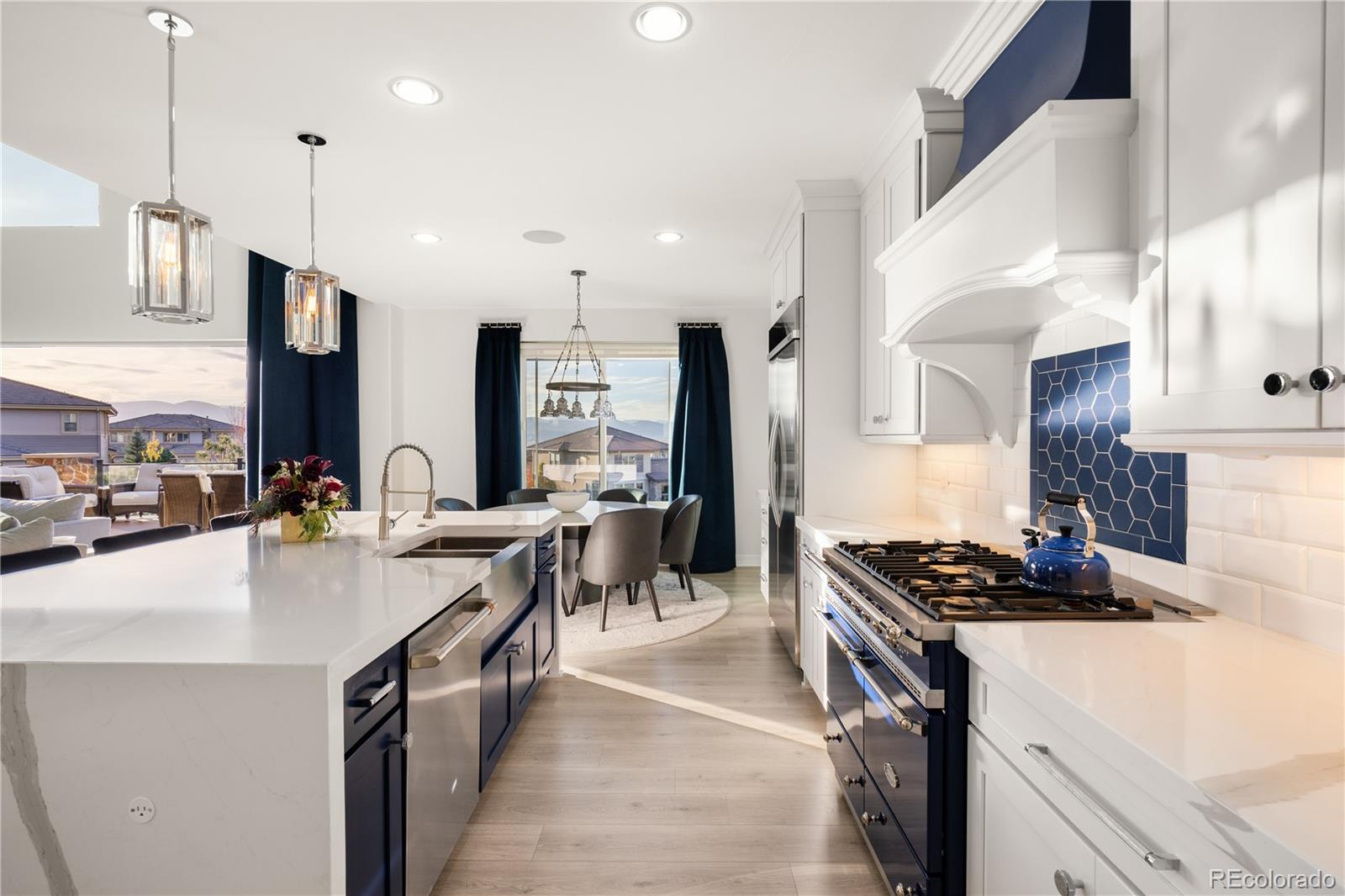10785 Sundial Rim Road Highlands Ranch, CO 80126 - Photo 8 of 43 a kitchen with stainless steel appliances a sink stove and refrigerator