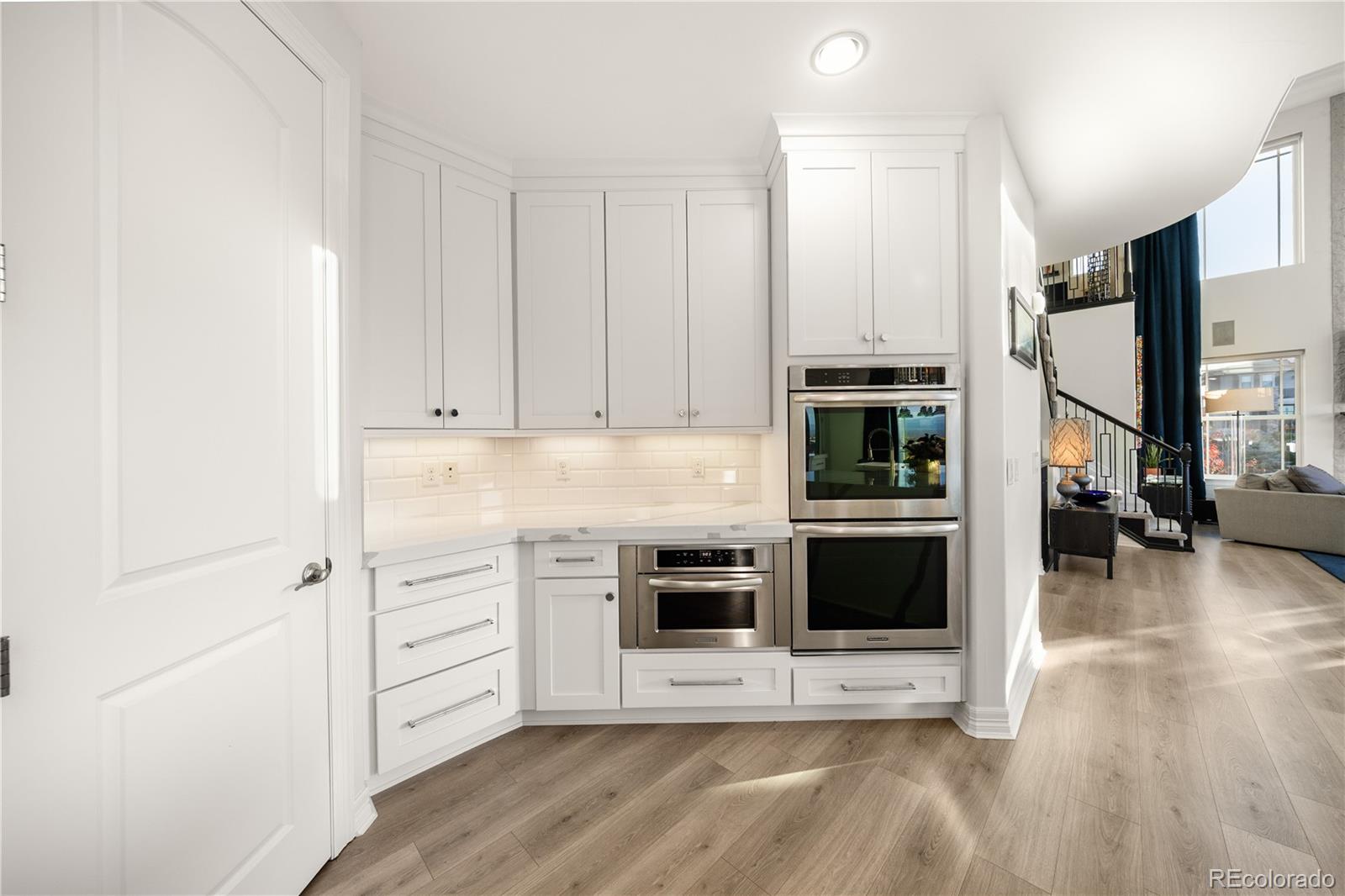 10785 Sundial Rim Road Highlands Ranch, CO 80126 - Photo 10 of 43 a view of a kitchen with stainless steel appliances and white cabinets
