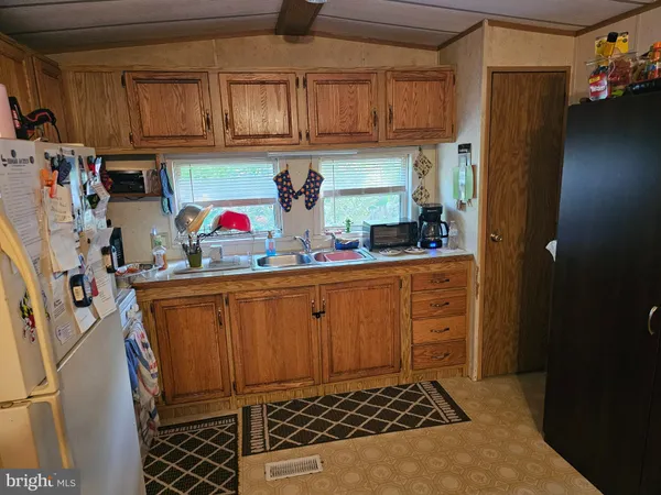 a kitchen with stainless steel appliances a refrigerator sink and cabinets