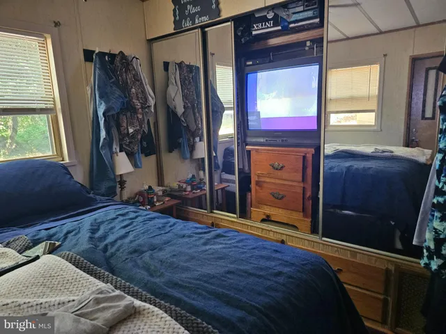 a bedroom with a bed and a closet