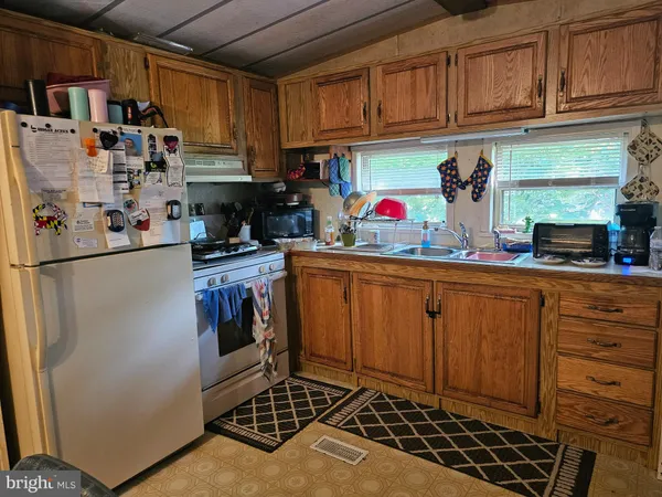 a kitchen with stainless steel appliances granite countertop a refrigerator and a stove top oven