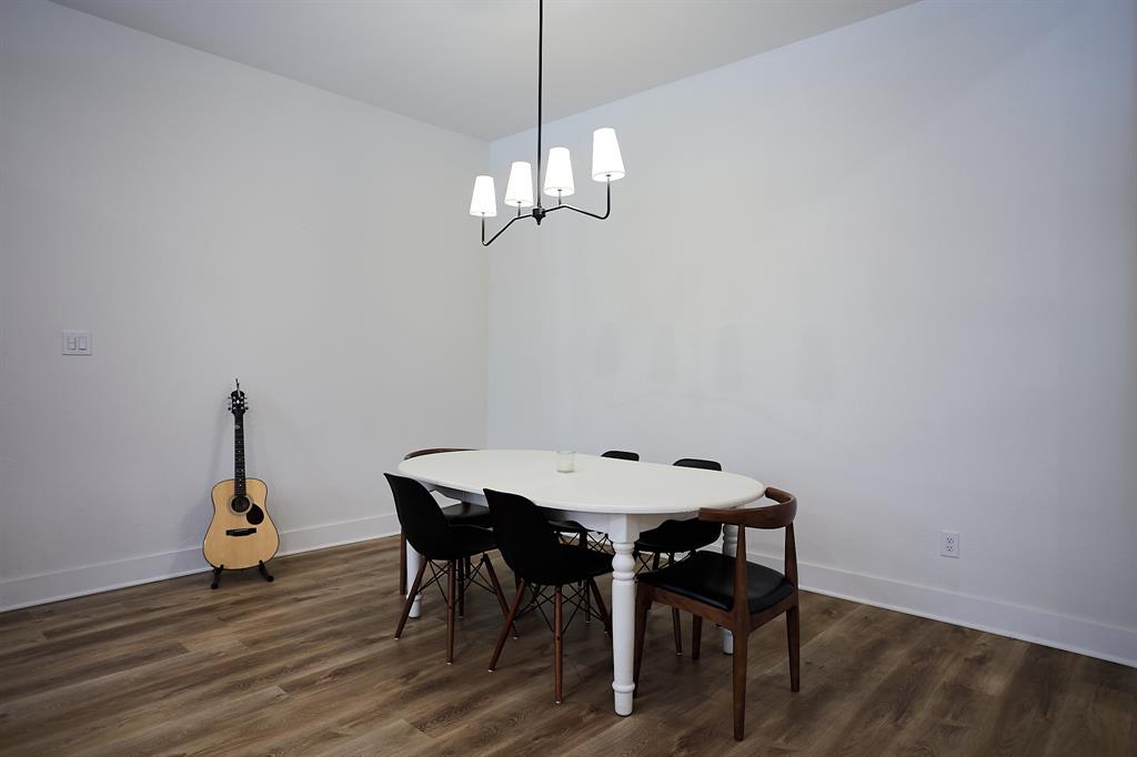 358 Glade Valley Road Azle, TX 76020 - Photo 10 of 35 Spacious room featuring wood-finish flooring, white walls, and a modern ceiling-mounted light fixture