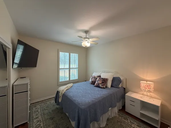 a bedroom with a bed and a flat screen tv