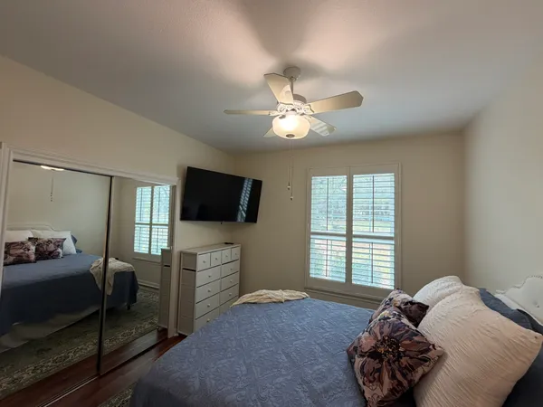 a bedroom with a bed and a television