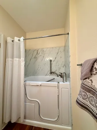 a bathroom with a granite countertop sink a toilet and shower
