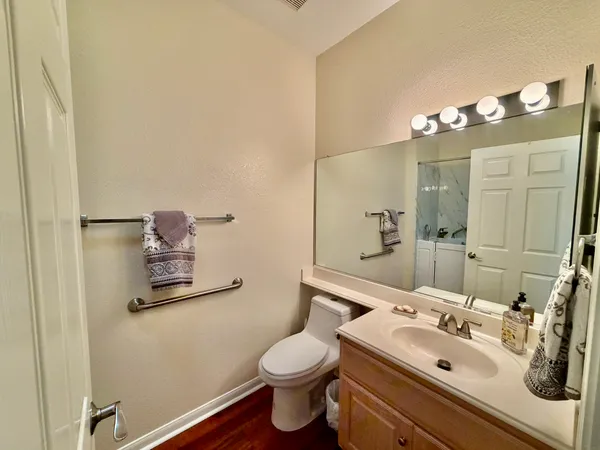 a bathroom with a sink vanity mirror and toilet