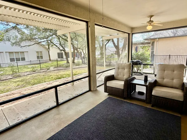 a living room with furniture and a floor to ceiling window