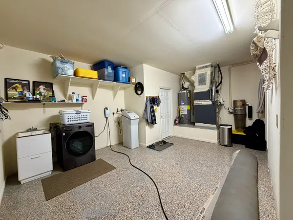 a utility room with sink dryer and washer