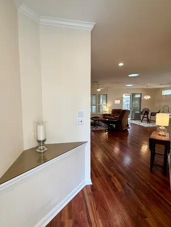 a view of living room with furniture and a wooden floor