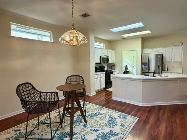 a view of a dining room with furniture and wooden floor