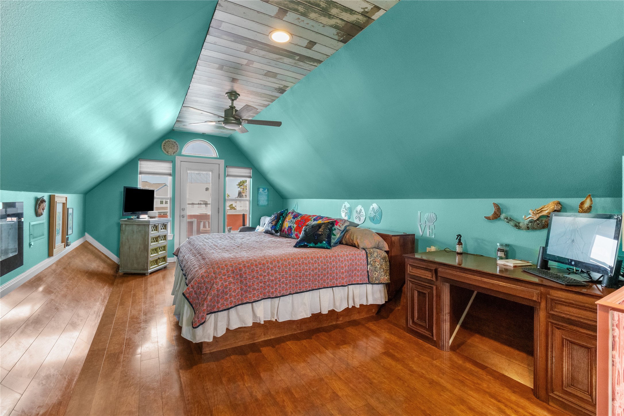 106 Isles End Road Tiki Island, TX 77554 - Photo 15 of 44 a bedroom with a bed and a flat tv screen on wall