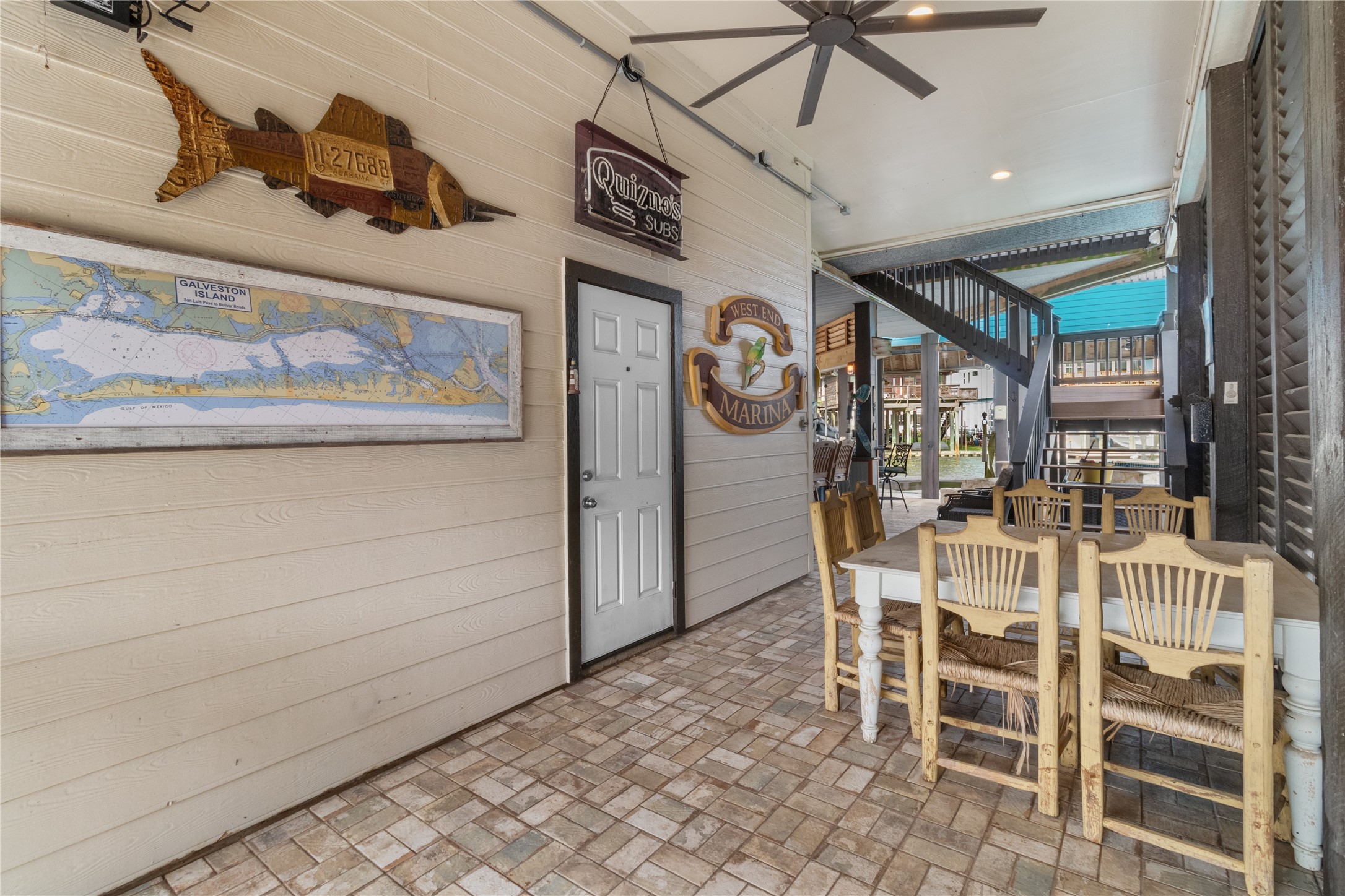106 Isles End Road Tiki Island, TX 77554 - Photo 28 of 44 a dining room with a wooden table and chairs