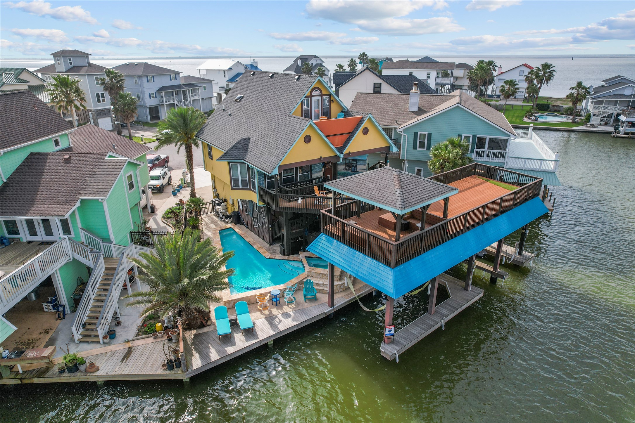 106 Isles End Road Tiki Island, TX 77554 - Photo 3 of 44 an aerial view of a house with swimming pool and a yard