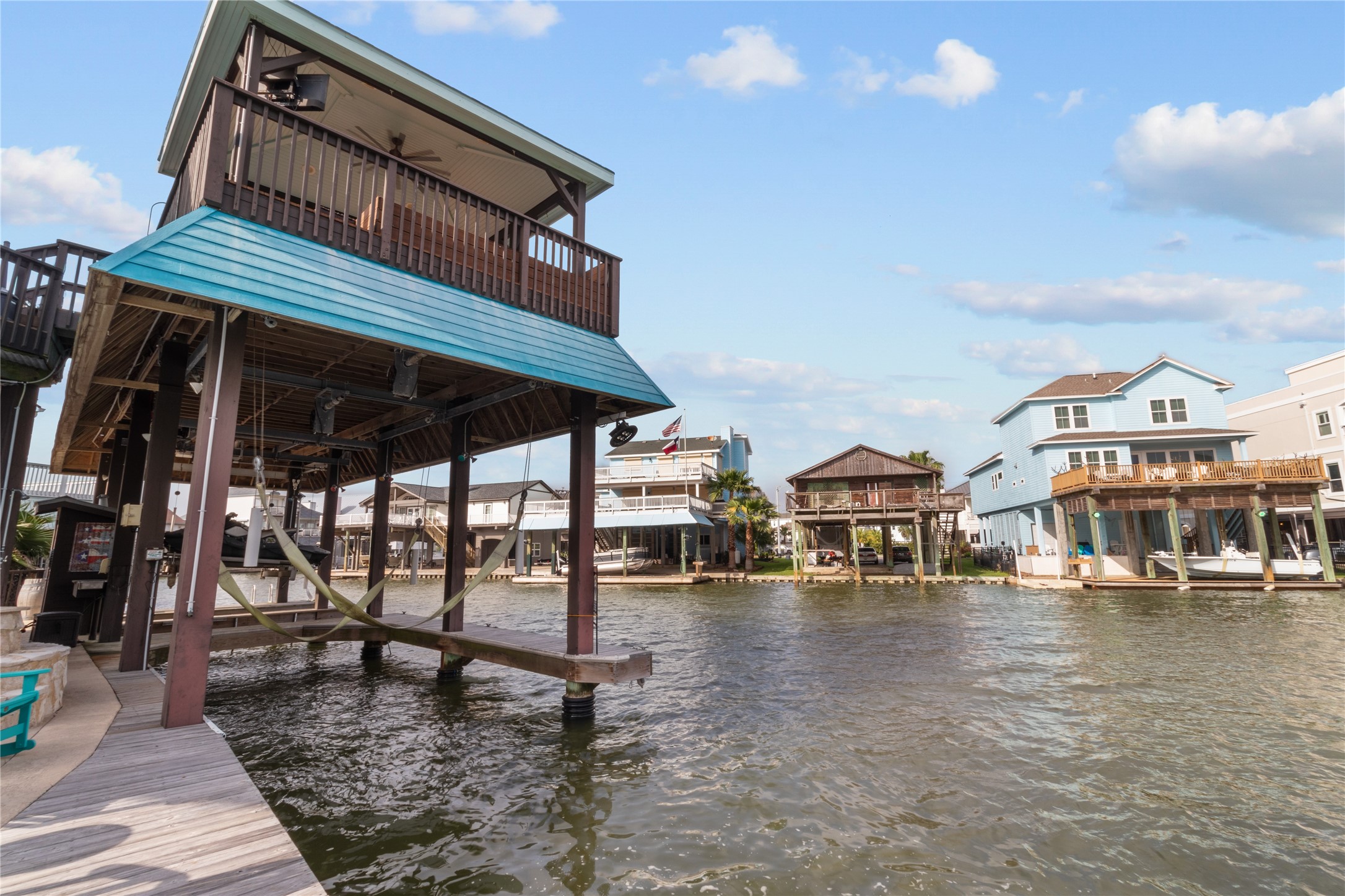 106 Isles End Road Tiki Island, TX 77554 - Photo 35 of 44 a front view of a building with glass top table and chairs